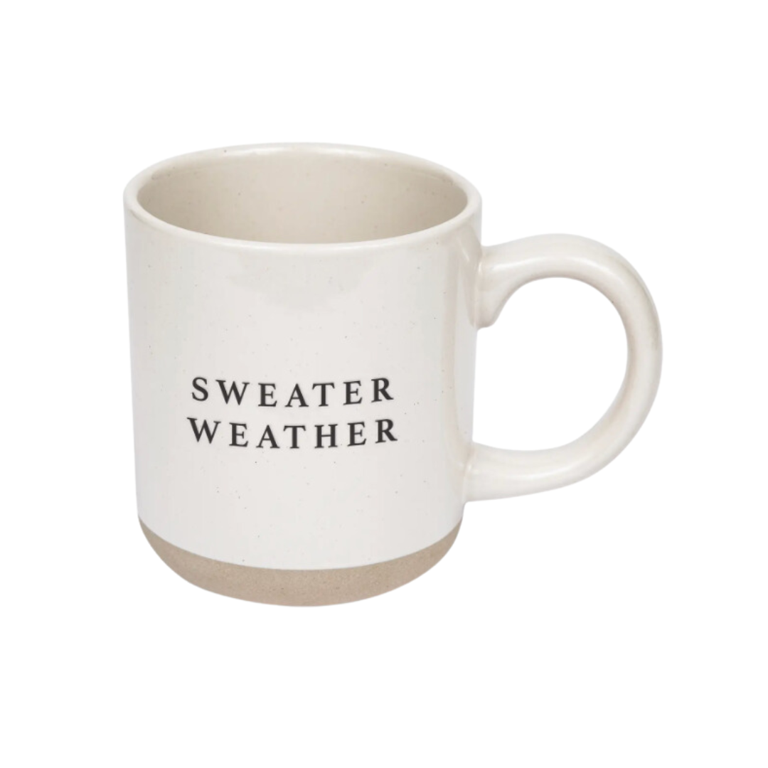 14oz stoneware mug with cream color and speckled design, featuring the cozy phrase 'Sweater Weather' in black capital  lettering on both sides.