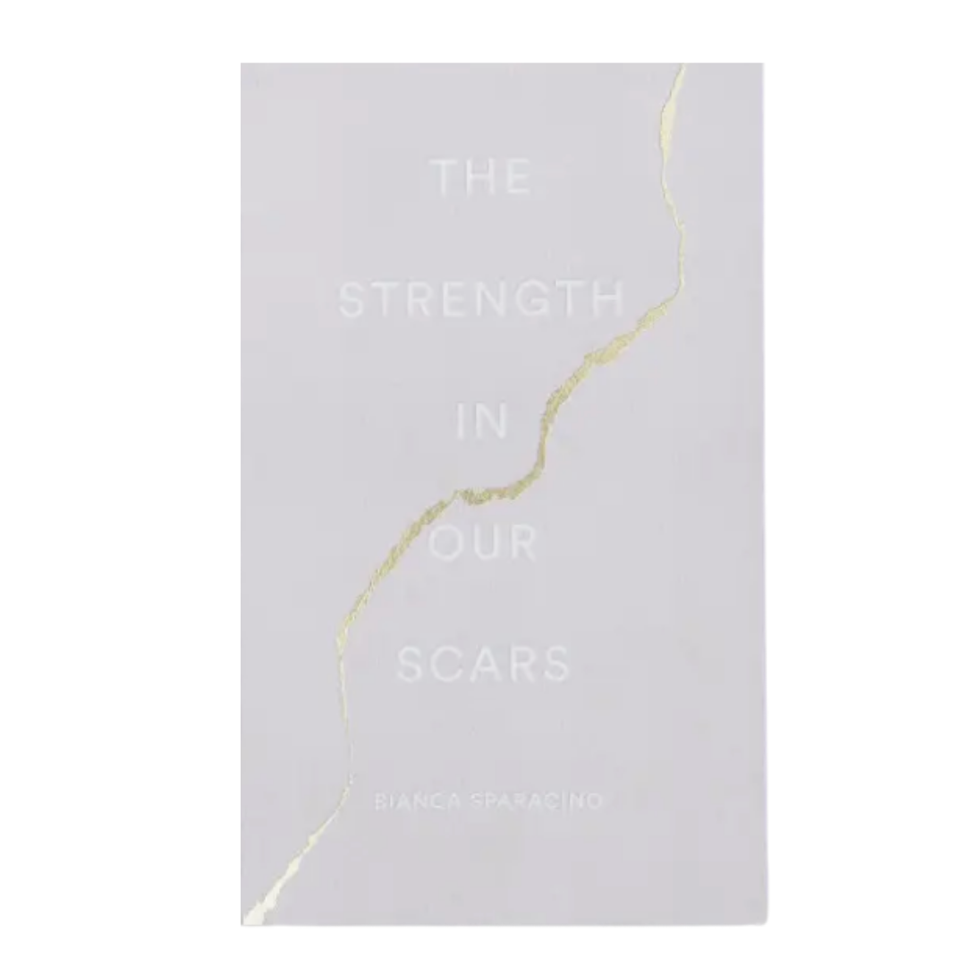 The Strength in Our Scars book by Bianca Sparacino, featuring a light gray cover with a diagonal gold foil crack design and embossed title text.