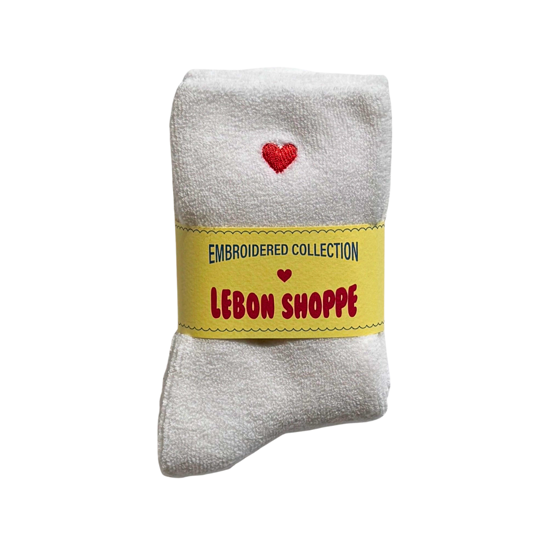 White sock with red embroidered heart at the top.