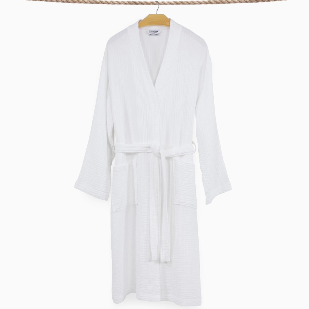 A luxurious white 100% cotton spa robe made from 4-ply gauze, showcasing its soft texture. Ideal for drying off after a shower or lounging at home, this robe offers both comfort and functionality.