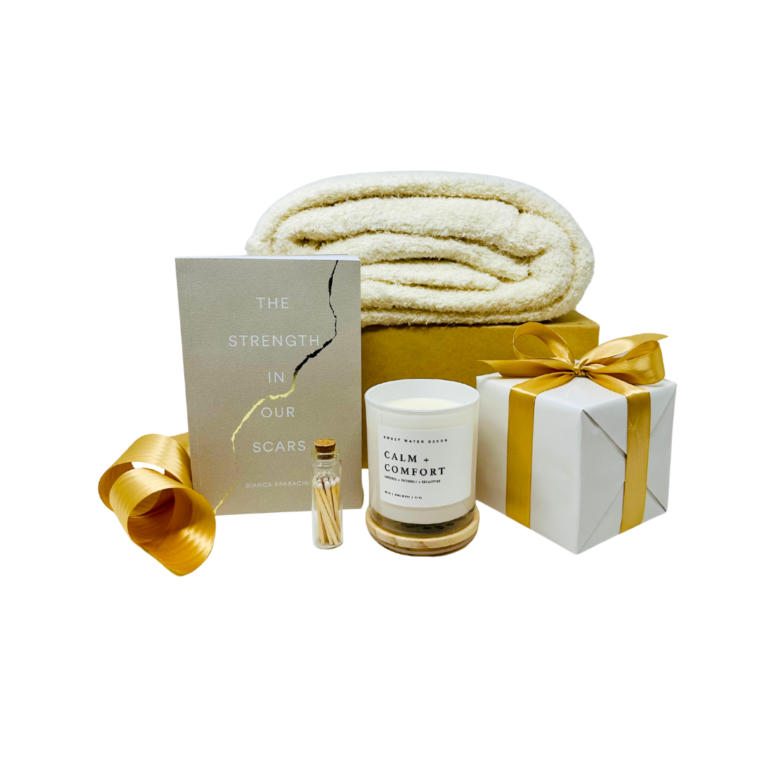 Thoughtfully curated condolence gift, With Sympathy. Elegant sympathy gift box featuring a selection of comforting items, including a candle, soft blanket, book, and heartfelt note, all arranged thoughtfully to express condolences.