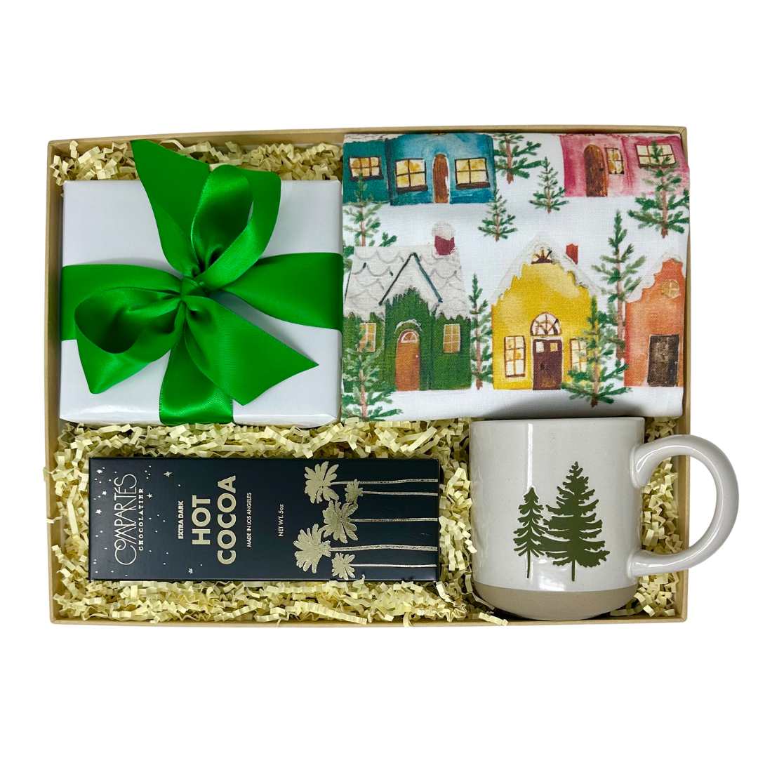 Gift set with mug, hot cocoa mix, and wrapped gift in decorative box.