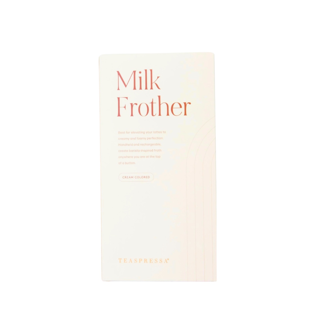 A cream-colored rectangular box for TEASPRESSA Milk Frother, featuring orange text and a subtle wavy line pattern, set against a plain white background.