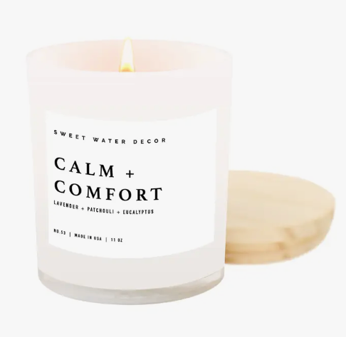 11oz white glass candle, 'Calm And Comfort,' features a wooden lid for a serene and soothing ambiance.